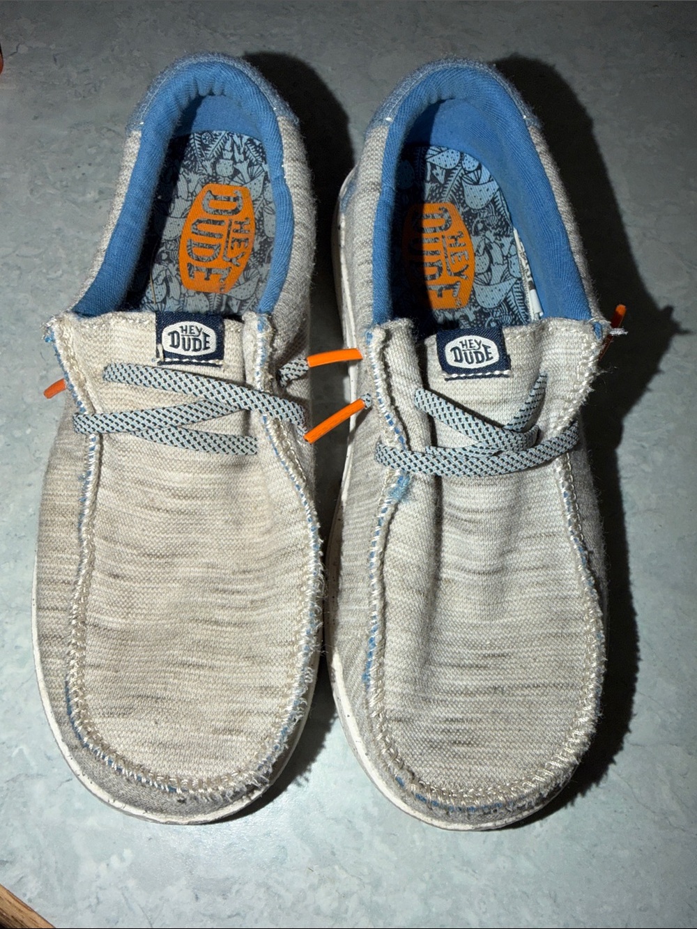 Hey Dude Kids Light Beige Canvas Slip-Ons with Blue Lining and Orange Accents